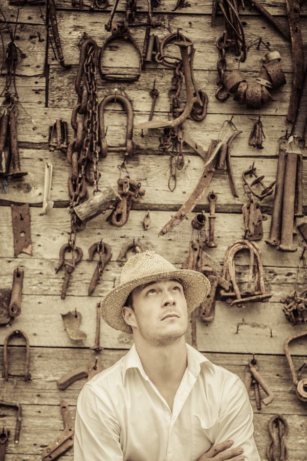 Farmer Portrait in front of a Wall Full of Tools royalty free stock photo Farmer Portrait in front of a Wall Full of Tools royalty free stock photo