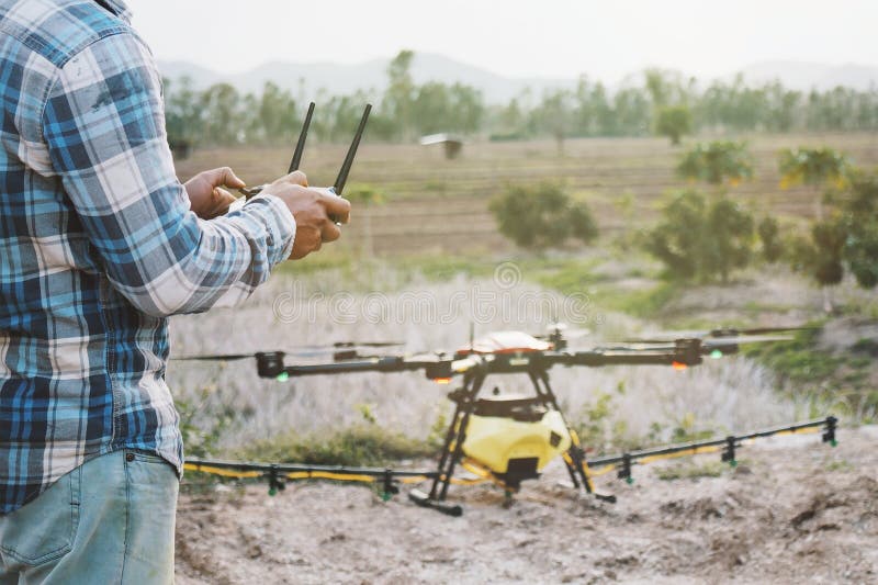 Farmer Using Drone Controller or Drone Transmitter a Remote Control for Agriculture Sprayer