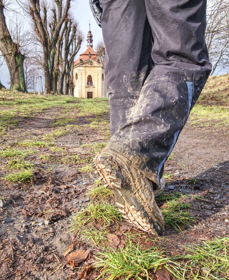 Farmer wearing muddy boots in daily business. Muddy rubber boot in horse farm area. Farmer wearing muddy boots in daily business. Muddy rubber boot in horse farm area