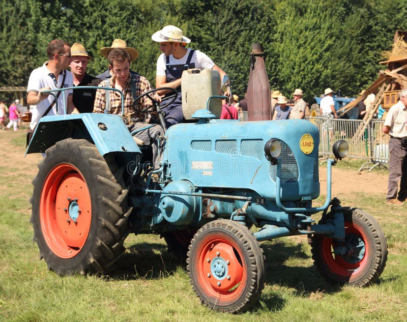 Farmers on an old tractor editorial stock image. Image of fete 92727069