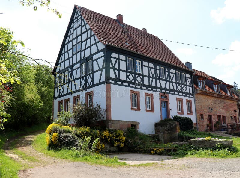 Farmhouse in a small village in Germany with a walking path leading into the forest stock photos Farmhouse in a small village in Germany with a walking path leading into the forest stock photos