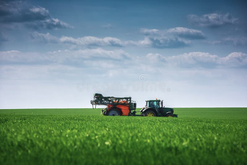 Farming tractor plowing and spraying on field stock images Farming tractor plowing and spraying on field stock images