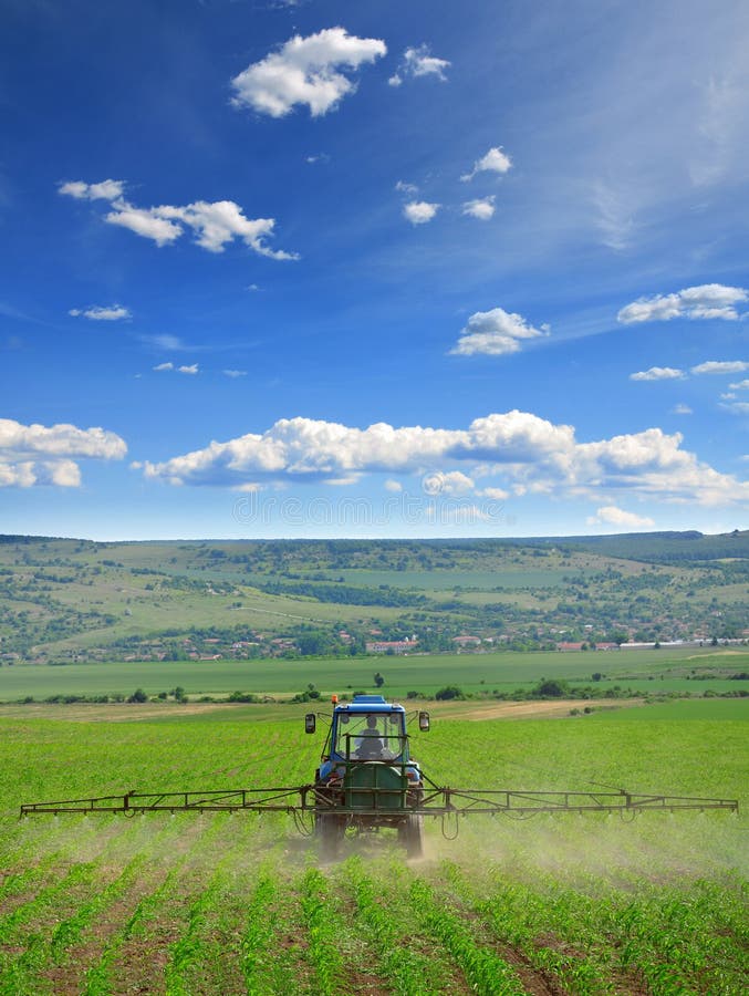 Farming tractor plowing and spraying on field royalty free stock images Farming tractor plowing and spraying on field royalty free stock images