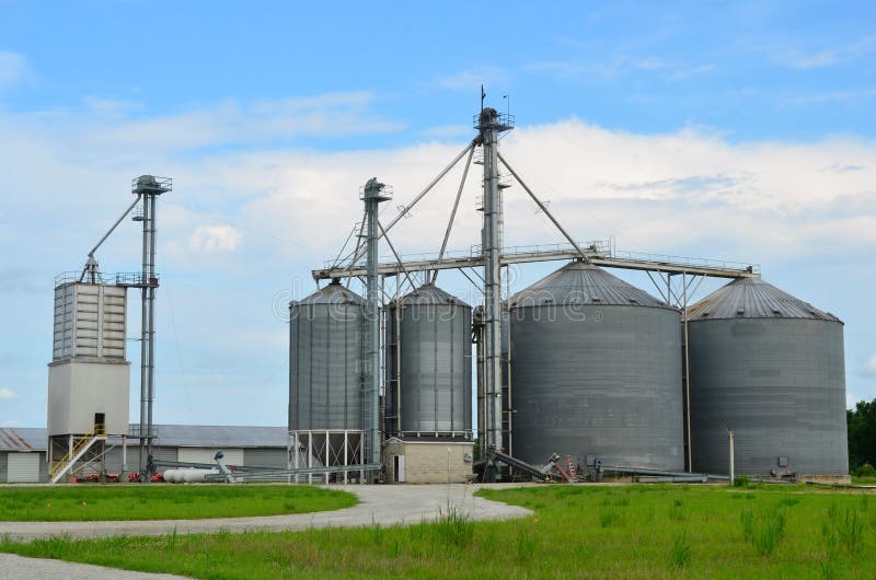 Farmland with Steel Grain Industrial Silo Towers