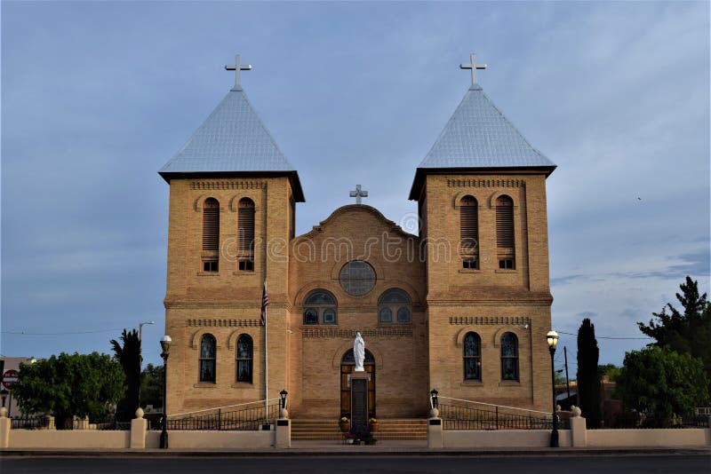 Tan brick bell towers under symmetrical silver roofs in soft morning light lend a gentle,welcome look to San Albino Parish Church, on the historic plaza in Mesilla New Mexico. Tan brick bell towers under symmetrical silver roofs in soft morning light lend a gentle,welcome look to San Albino Parish Church, on the historic plaza in Mesilla New Mexico