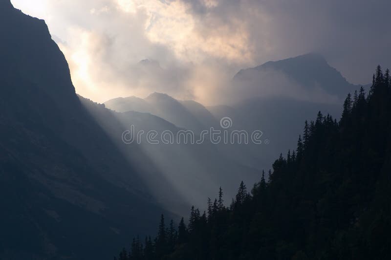 Solar beams and fog in mountains. Solar beams and fog in mountains