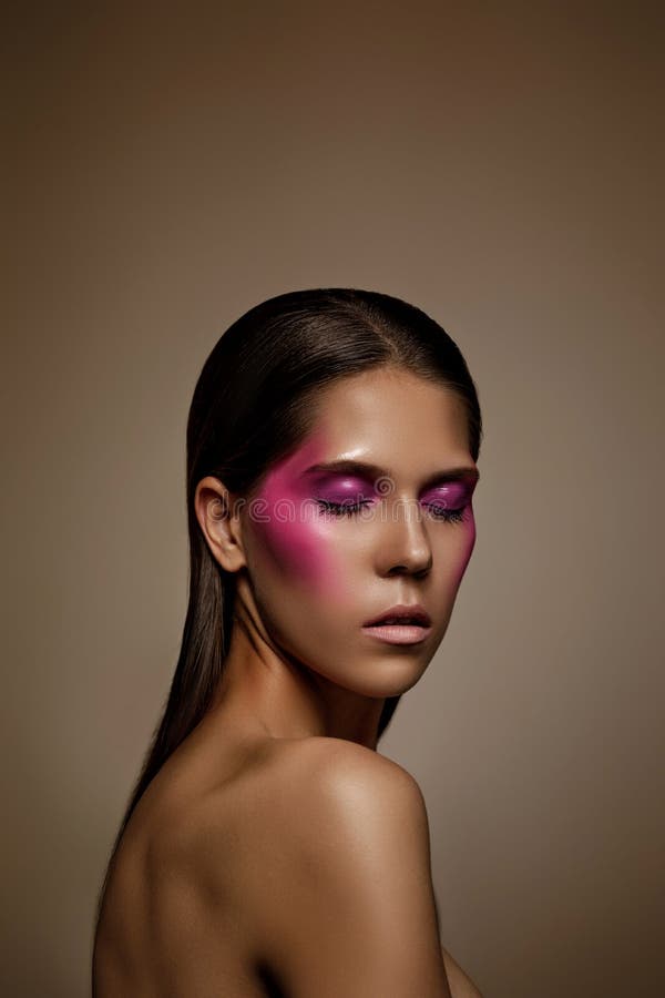 Fashion art skin woman face portrait closeup. Glamour shiny professional makeup girl with trendy pink make-up stock photography Fashion art skin woman face portrait closeup. Glamour shiny professional makeup girl with trendy pink make-up stock photography