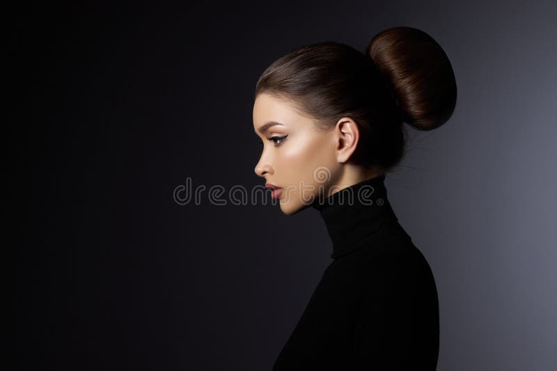 Fashion art studio portrait of beautiful elegant woman in black turtleneck. Hair high beam, perfect profile face. Elegant beauty