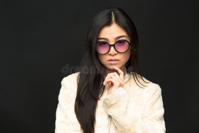 Fashion asian model woman in sunglasses in studio