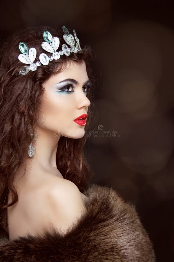 Fashion beautiful woman posing in fur coat. Winter Girl Model in