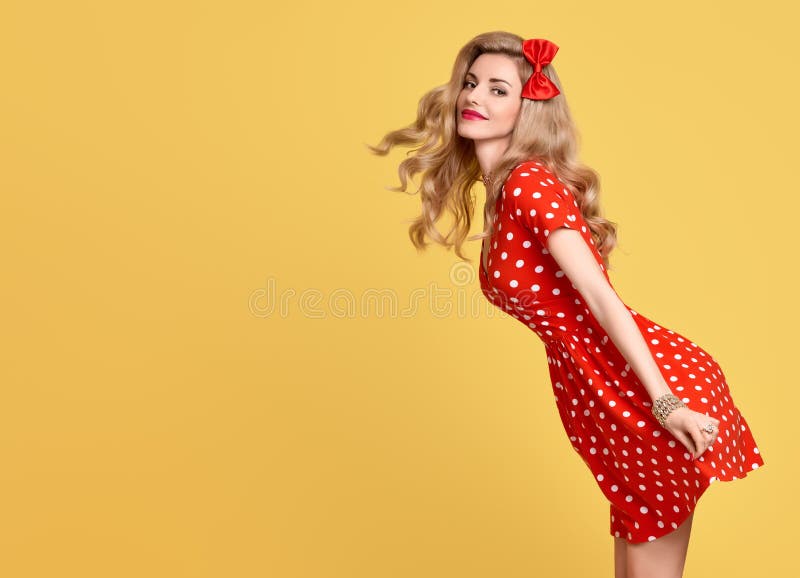 Fashion Beauty. PinUp Sensual Blond Girl Smiling in Red Polka Dots Summer Dress. Woman in fashion pose. Trendy Stylish Curly hairstyle, fashion Makeup, red Bow. Glamour Playful pinup Model Lady. Fashion Beauty. PinUp Sensual Blond Girl Smiling in Red Polka Dots Summer Dress. Woman in fashion pose. Trendy Stylish Curly hairstyle, fashion Makeup, red Bow. Glamour Playful pinup Model Lady