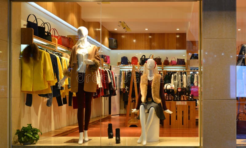 Fashion boutique display window with mannequins, go shopping, dress shop window