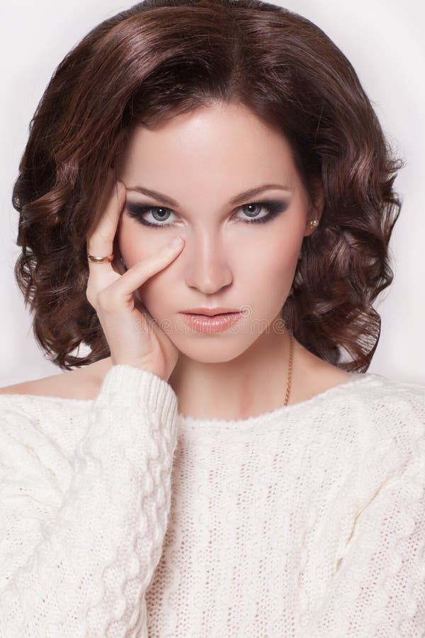 Fashion brunette woman with brown curly hair girl with perfect skin and makeup. Beauty Model retro