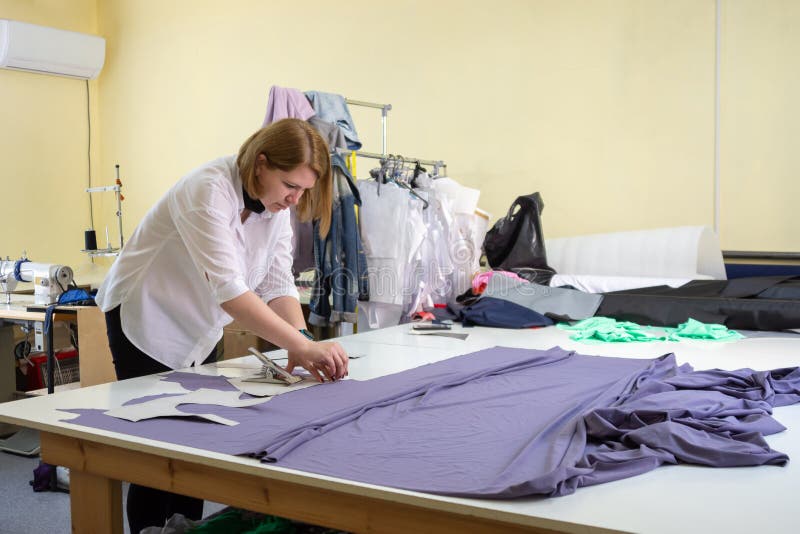 Fashion Designer Cuts on the Material Details of Clothes in the