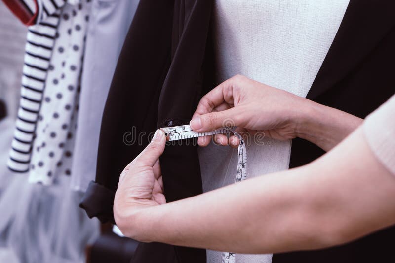 Fashion Designer hand measuring clothes with measuring tape stock images Fashion Designer hand measuring clothes with measuring tape stock images