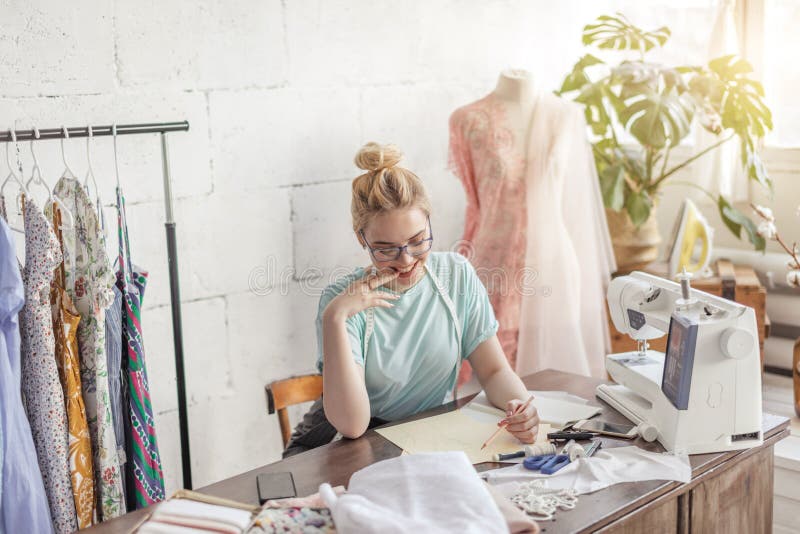 Fashion Designer at Work. Talanted Dressmaker Drawing Sketch at Her ...