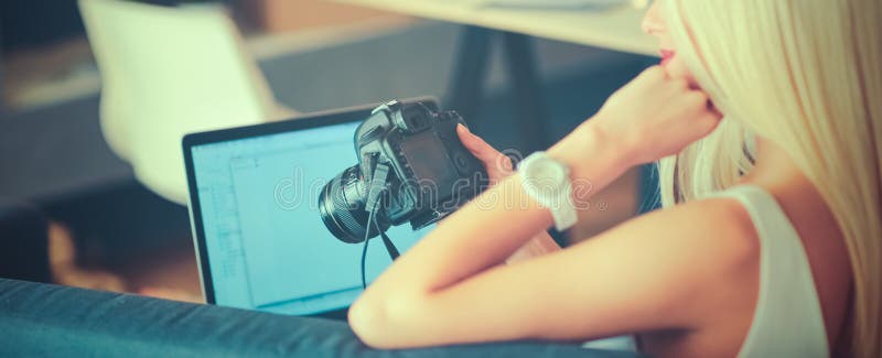Fashion designers working in studio sitting on the desk stock image Fashion designers working in studio sitting on the desk stock image
