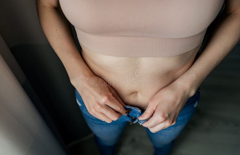Woman With Belly Fat Getting Dressed Putting Pants On. Overweight