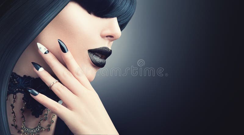 Fashion Halloween model girl with gothic black hairstyle, makeup and manicure