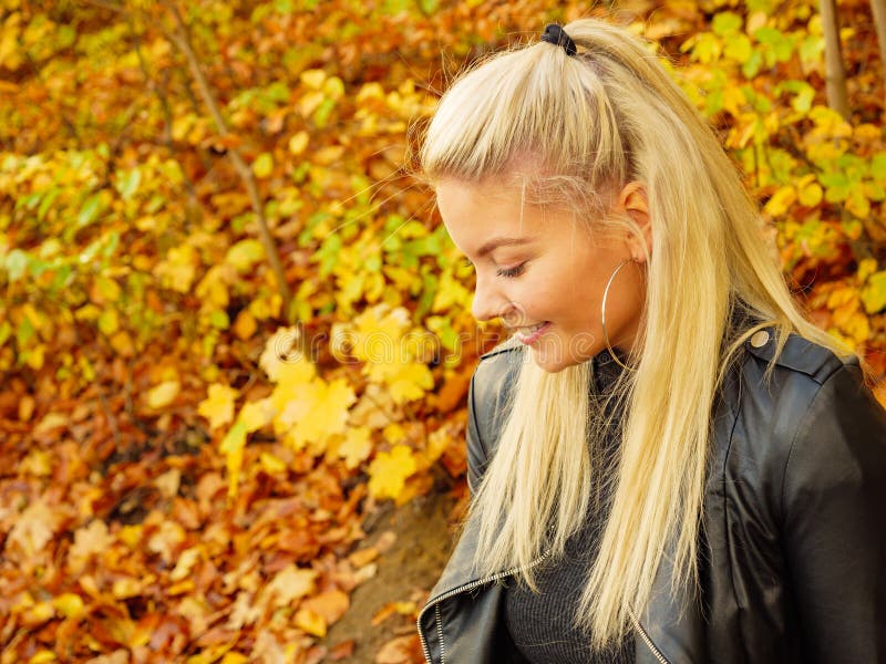 Fashion-kvinnans avslappning i höstparken royaltyfri bild