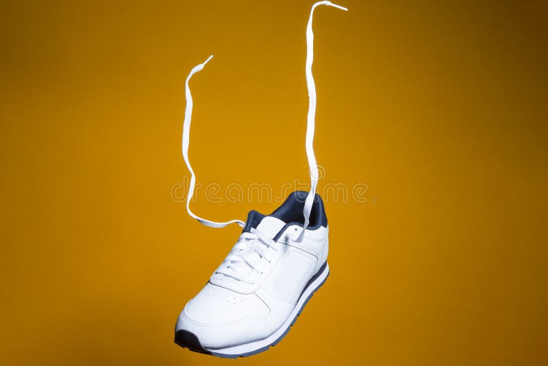 Fashion and Lifestyle Concepts. One New White Sneaker with Flying ...