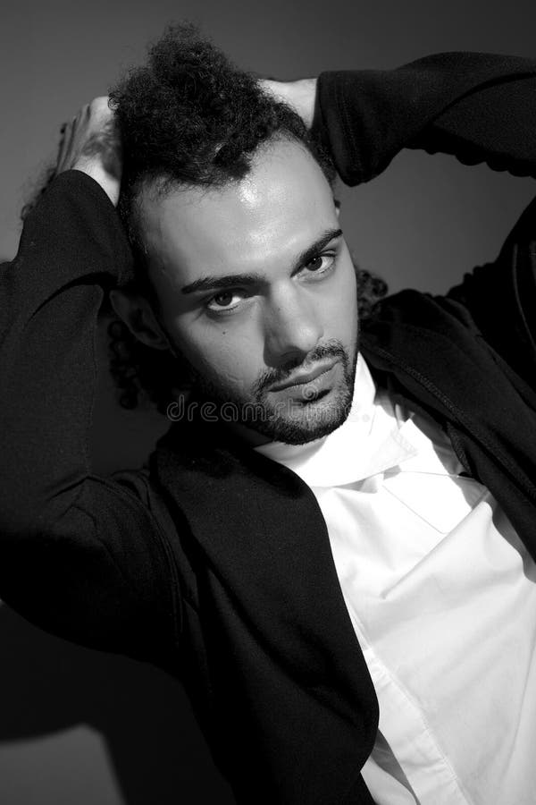 Fashion male model holding curly hair black and white portrait royalty free stock images Fashion male model holding curly hair black and white portrait royalty free stock images
