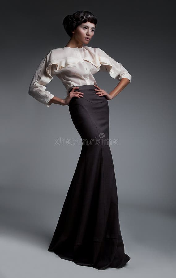 Fashion model attractive brunette in long dress