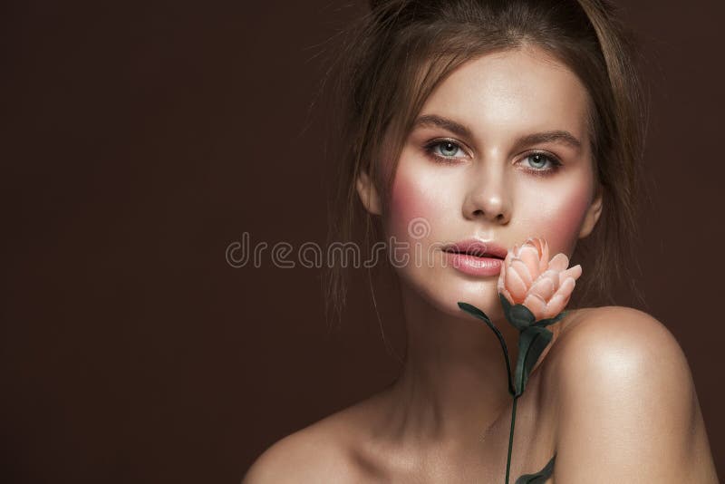 Fashion Model Beauty Makeup Dishevel Hairstyle with Flower, Beautiful Woman Studio Portrait. Girl looking at camera stock images Fashion Model Beauty Makeup Dishevel Hairstyle with Flower, Beautiful Woman Studio Portrait. Girl looking at camera stock images