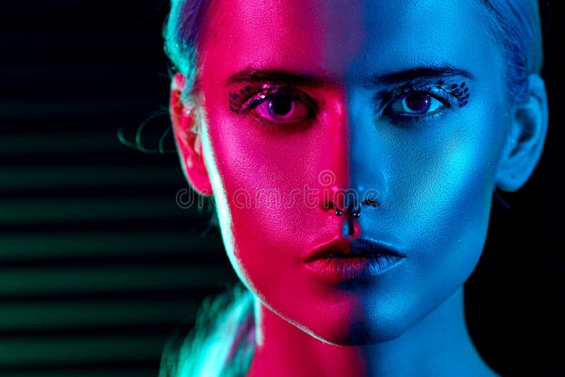 Fashion model blonde woman in colorful bright neon lights