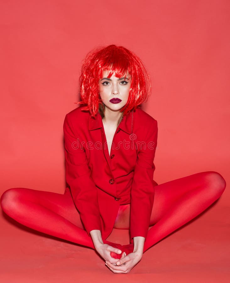 Fashion model. Fashion model in red clothes. Fashion model with glamour look. Fashion model wear funky wig hair. Express royalty free stock photos Fashion model. Fashion model in red clothes. Fashion model with glamour look. Fashion model wear funky wig hair. Express royalty free stock photos