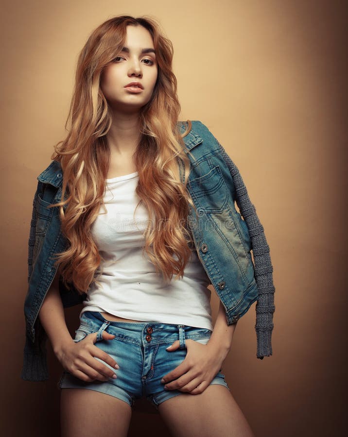 Fashion Model in Nice Clothes Posing in the Studio on Yellow Background