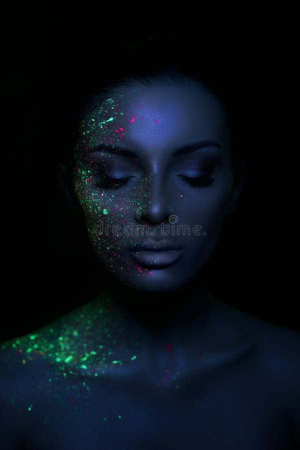Fashion model woman in neon light bright fluorescent makeup, drop on face. Beautiful model brunette girl colorful make-up, painted royalty free stock image Fashion model woman in neon light bright fluorescent makeup, drop on face. Beautiful model brunette girl colorful make-up, painted royalty free stock image