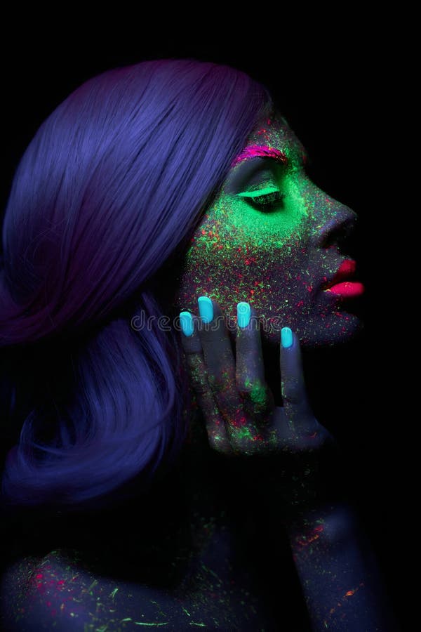 Fashion model woman in neon light bright fluorescent makeup, long hair, drop on face. Beautiful model pink hair girl colorful make royalty free stock photos Fashion model woman in neon light bright fluorescent makeup, long hair, drop on face. Beautiful model pink hair girl colorful make royalty free stock photos