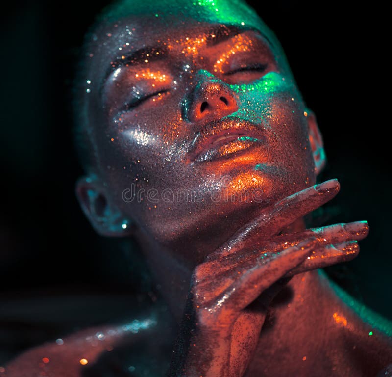 Fashion model woman skin face in bright sparkles, colorful neon lights, beautiful sexy girl portrait. Trendy glowing colorful skin