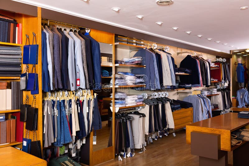 Fashion Modern Men Clothes Displayed on Shelves and Hanger Racks in ...