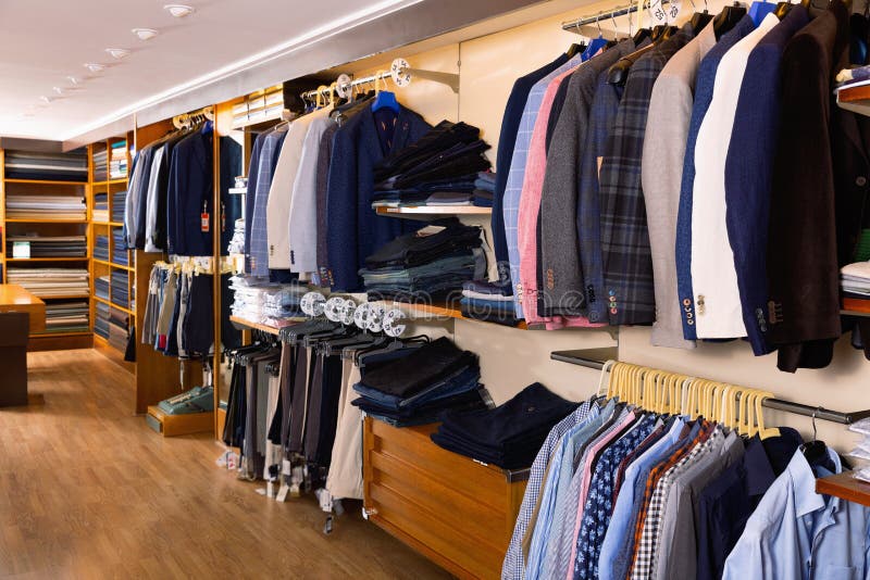 Fashion Modern Men Clothes Displayed on Shelves and Hanger Racks in ...