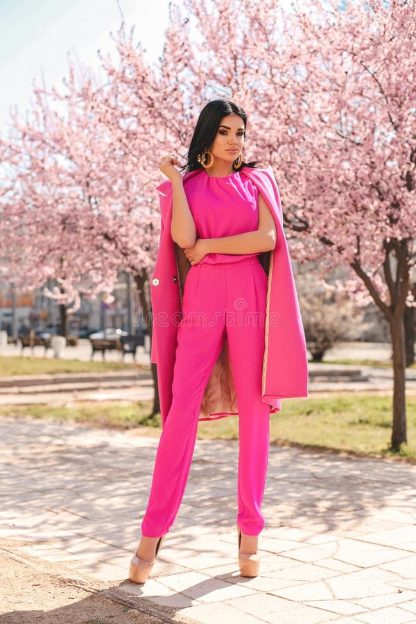 Fashion Outdoor Photo Of Beautiful Sexy Woman With Dark Hair In Elegant Red  Suit With Accessories Walking By The Street Stock Photo, Picture and  Royalty Free Image. Image 119892401.