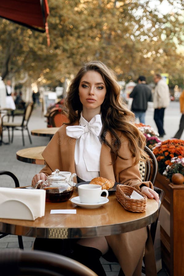 Beautiful Woman with Dark Hair in Elegant Outfit Sitting in Cafe Stock ...