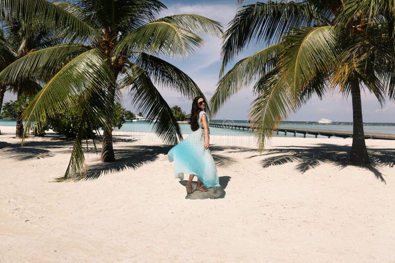 Woman In Elegant Beach Clothes Relaxing On Maldives Island Stock Photo
