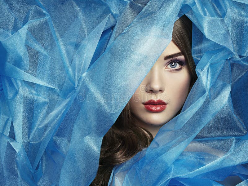 Fashion photo of beautiful women under blue veil