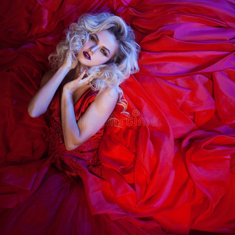 Fashion photo of young magnificent woman in red dress. Studio portrait royalty free stock photography Fashion photo of young magnificent woman in red dress. Studio portrait royalty free stock photography