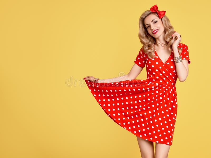 Fashion Woman Smiling in Red Polka Dots Summer Dress. PinUp Sensual Blond Girl Having fun. Trendy Stylish Curly hairstyle, Makeup, red Bow. Glamour Playful Beauty pinup Model. Vintage on Yellow. Fashion Woman Smiling in Red Polka Dots Summer Dress. PinUp Sensual Blond Girl Having fun. Trendy Stylish Curly hairstyle, Makeup, red Bow. Glamour Playful Beauty pinup Model. Vintage on Yellow