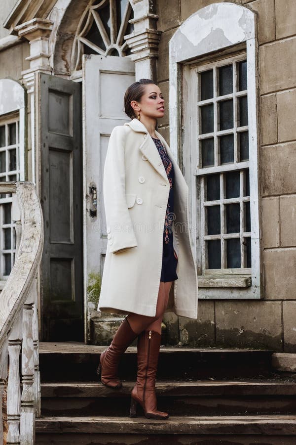 Fashion portrait of beautiful woman on the front of old vintage building