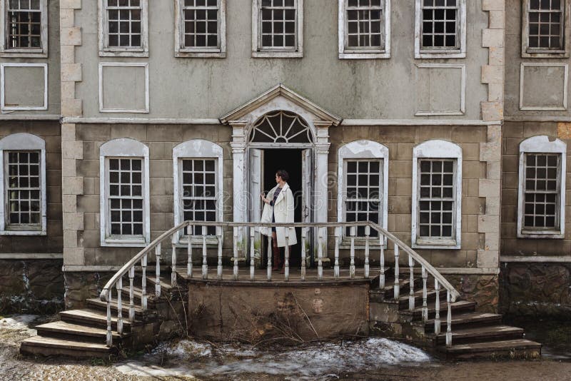 Fashion portrait of beautiful woman on the front of old vintage building