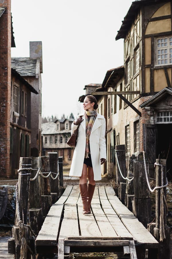 Fashion portrait of beautiful woman in old vintage street