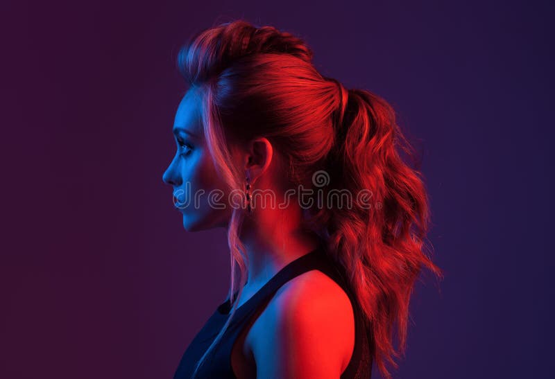 Fashion portrait of beautiful woman profile. Colorful light.