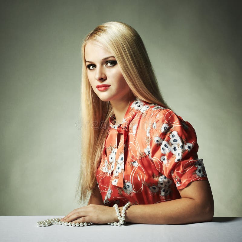 Fashion portrait of the blonde woman in red dress