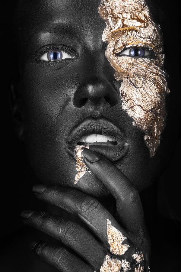 Fashion portrait of a dark-skinned girl with gold
