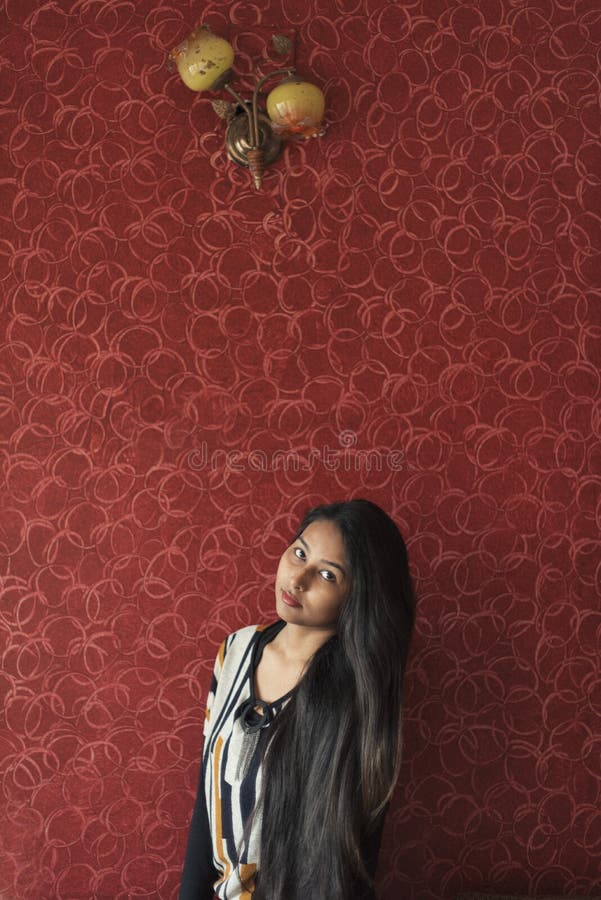 Fashion Portrait of an Indian Bengali Beautiful and Young Girl in Western  Dress Standing in Front of a Red Textured Wall. Stock Image - Image of  brunette, hair: 188480707