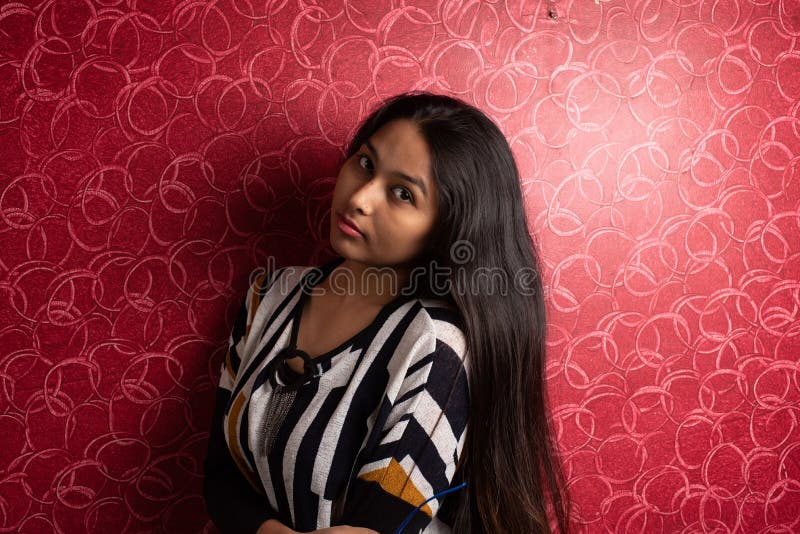 Fashion Portrait of an Indian Bengali Beautiful and Young Girl in Western  Dress Standing in Front of a Red Textured Wall. Stock Image - Image of  cute, hair: 188485909